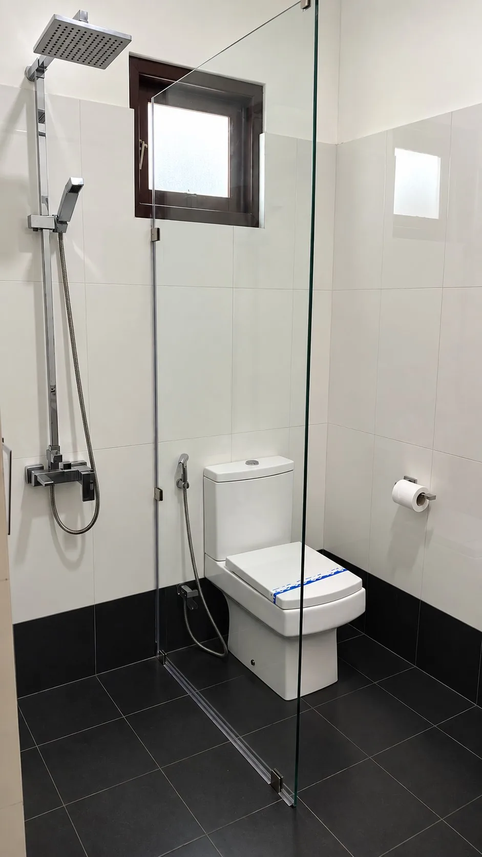 Deluxe Room — private attached bathroom with glass-partition shower