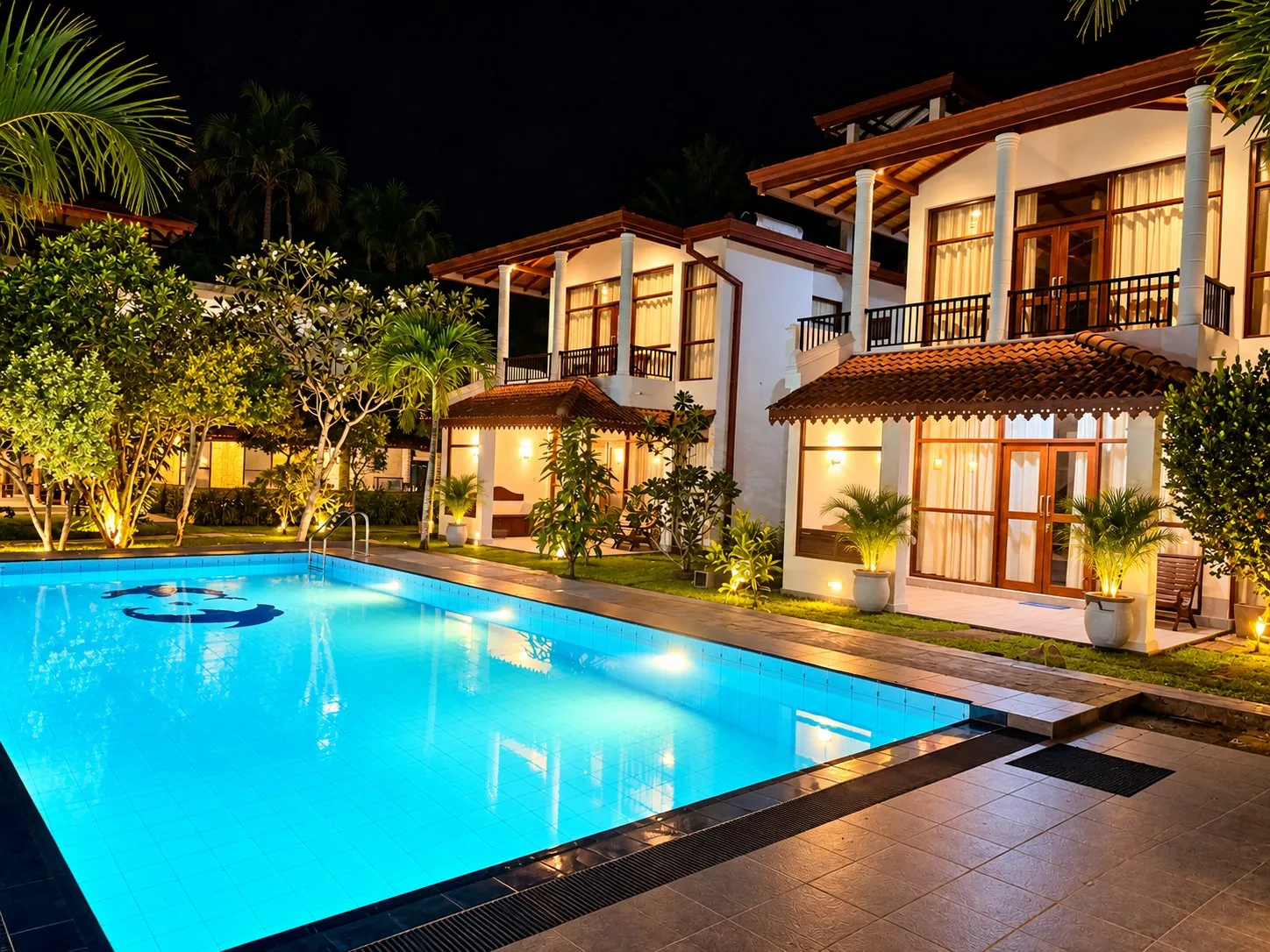 The property and pool lit up at night
