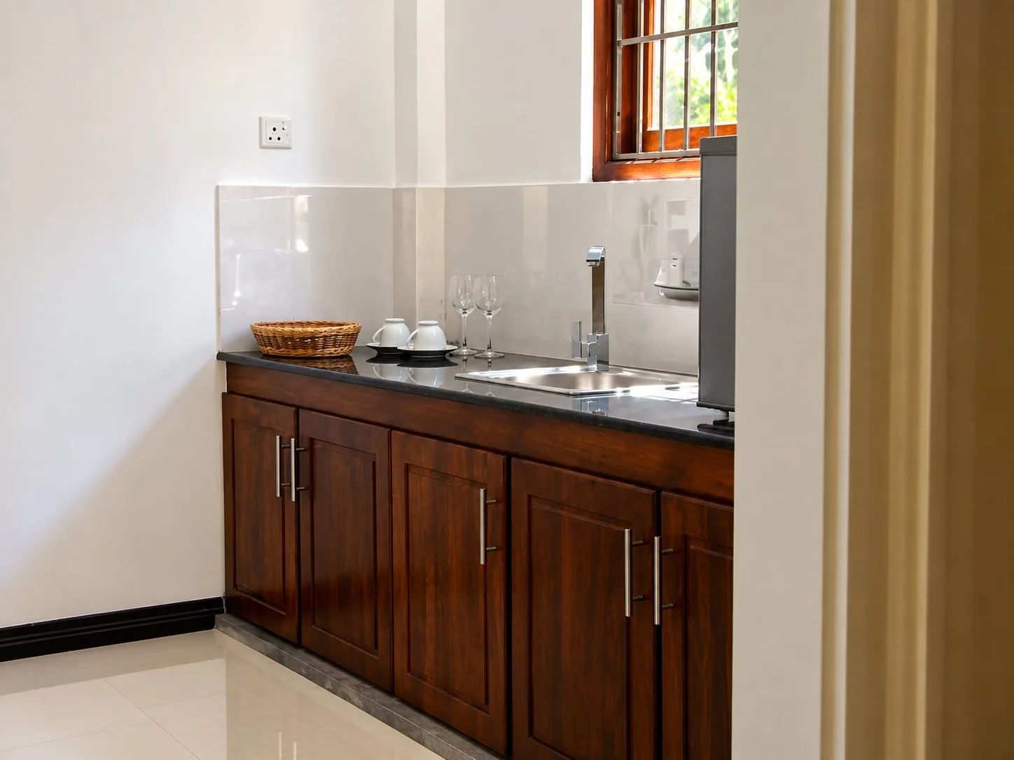 Suite kitchenette — timber cabinets, sink and worktop